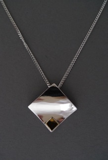 Hänge med kedja
"Kvadrat på kvadrat".
Silver och guld (2010).
Pris 1 200 kr. Hänge med kedja
"Kvadrat på kvadrat".
Silver och guld (2010).
Pris 1 200 kr.